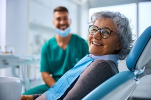 Woman smiling getting dental implants exam